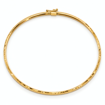 4mm 10k yellow gold textured flexible bangle bracelet with a box clasp, on a white background.