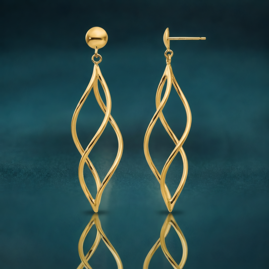 Long open twisted spiral dangle earrings in 10k yellow gold on ball posts, on a reflective teal surface.