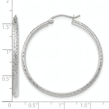 10k white gold diamond-cut hoop earrings, front and side view on a white background with an inch scale.