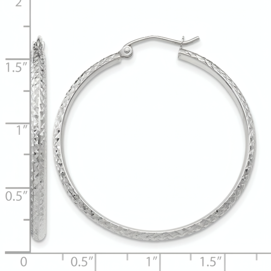10k white gold diamond-cut hoop earrings, front and side view on a white background with an inch scale.