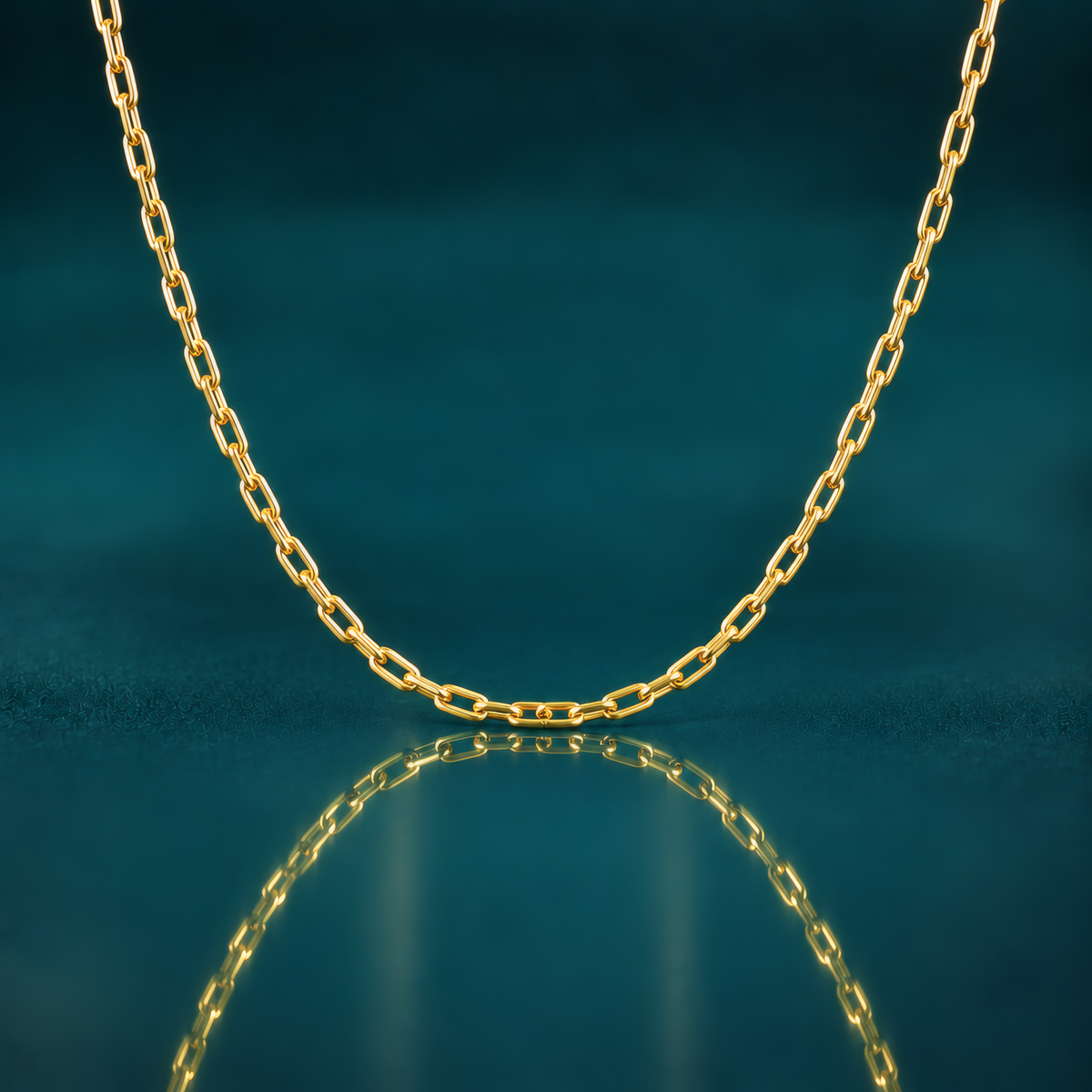Classy 16" delicate 2.2mm 14k yellow gold paperclip chain on a reflective blue surface.