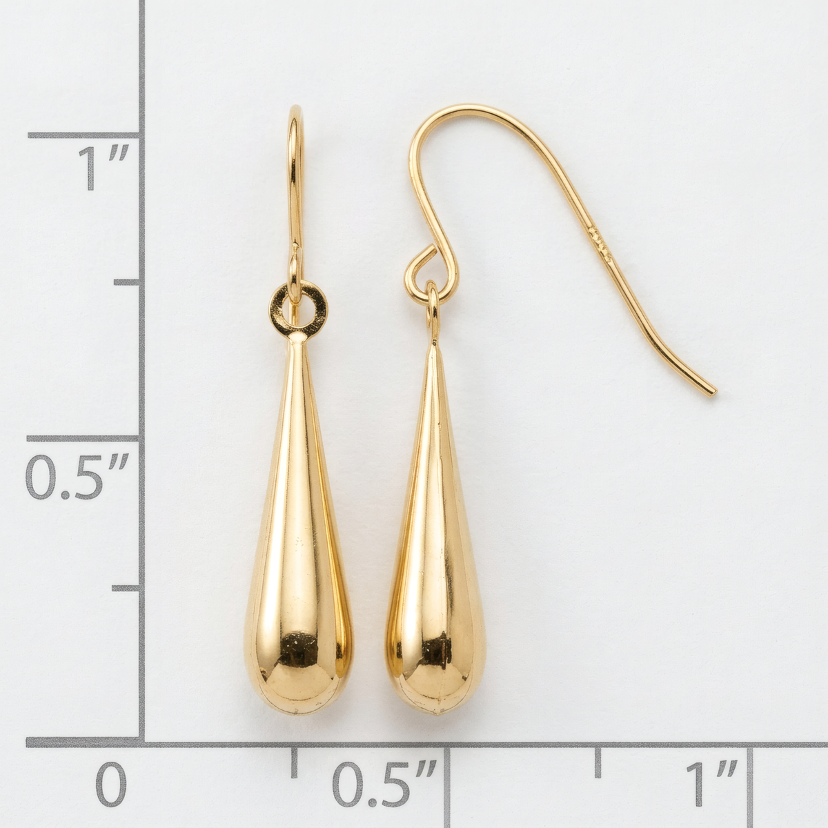 Polished 14k yellow gold teardrop dangle earrings on French hooks, on a white background with an inch scale.