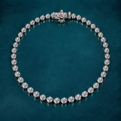 3 carat lab-grown diamond tennis bracelet in sterling silver with bezel-set round diamonds, on a teal background.