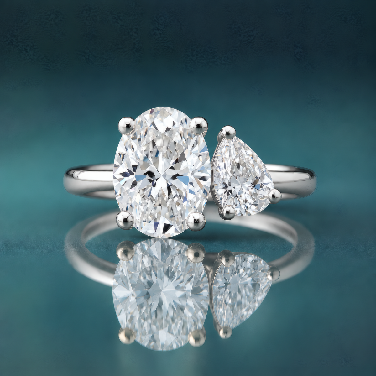 White gold two-stone engagement ring oval diamond pear diamond