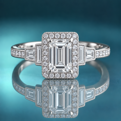Unique white gold halo engagement ring with an emerald-shaped center and 2 baguette diamonds on each side of the halo, moving down the shank. The rest of the shank is set with round diamonds via prong in channel.