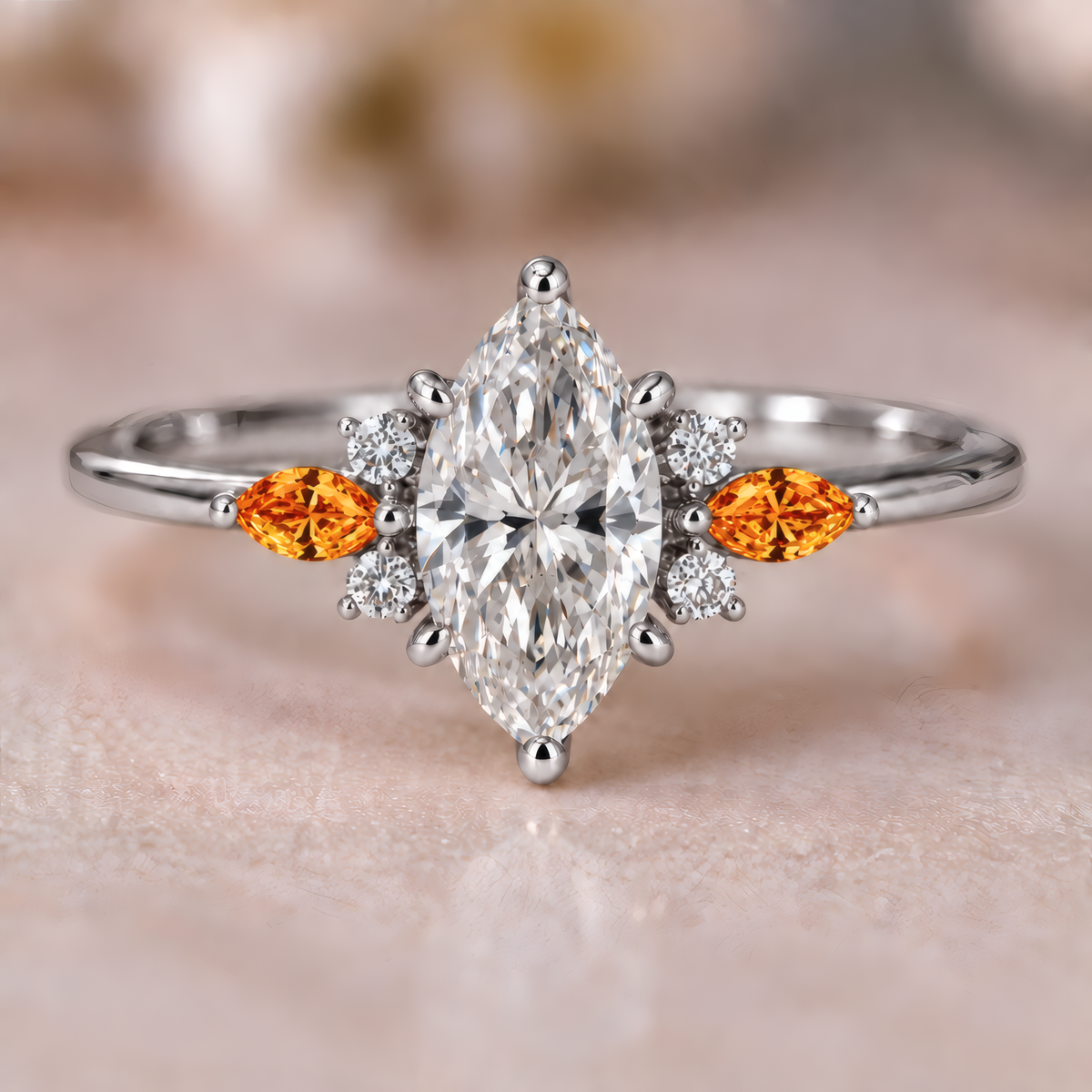 A white gold engagement ring with a striking marquise center diamond, flanked on each side by a fiery amber marquise accent and a cluster of sparkling round diamonds that catch the light. A slender, polished band keeps the look delicate and refined.