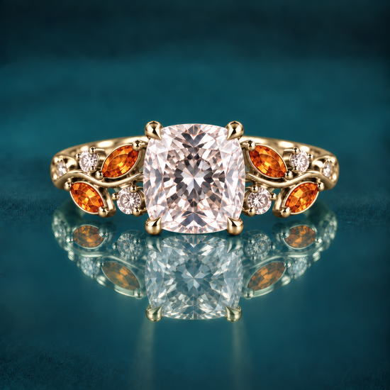 Gold engagement ring with a cushion-cut diamond atop a delicate vine band, woven with fiery amber marquise leaves and twinkling round diamonds for a romantic, nature-inspired look.