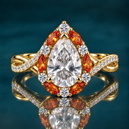 Bourke engagement ring in yellow gold with a pear-shaped diamond in a halo of amber marquise stones and round diamonds on a twisted pavé band