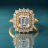 Gold double halo engagement ring with an emerald-shaped center stone