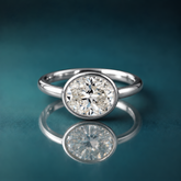 White gold solitaire bezel oval engagement ring