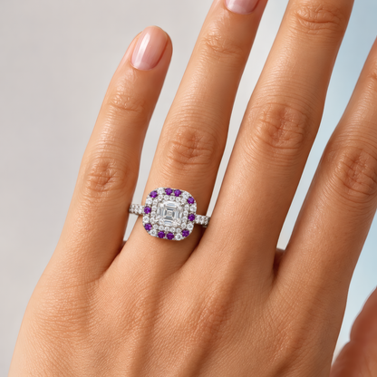 Kea engagement ring in white gold worn on a woman's hand, showing the Asscher-cut diamond in a double halo of diamonds and purple stones