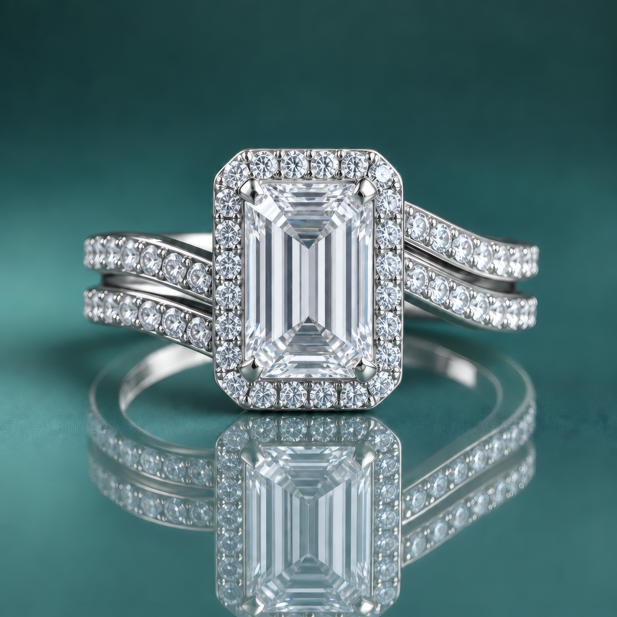 White gold halo engagement ring with an emerald-shaped center diamond and a curving double shank set with small diamonds.