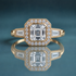 Unique gold halo three-stone engagement ring with an asscher-shaped center stone, a halo of small round diamonds, and a large tapered baguette on each side of the halo. Milgrain surrounds the outer halo and the tapered baguettes.