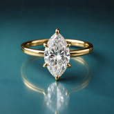 Delicate gold marquise diamond solitaire engagement ring