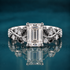 Noctis pairs white gold with an emerald-cut diamond with a winding vine band set with deep black marquise accents and sparkling round diamonds, a striking contrast of light and shadow.