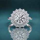 white gold double halo engagement ring featuring a round center diamond and a narrow shank.