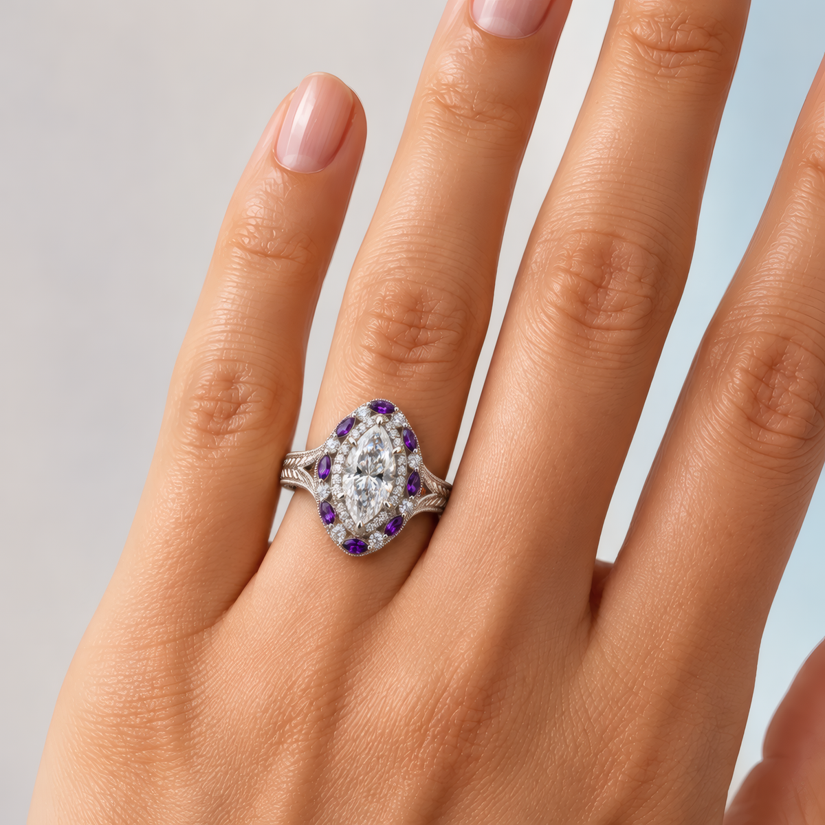 Plum engagement ring in white gold worn on a woman's hand, showing the marquise diamond in a double halo of purple marquise stones on a split-shank band