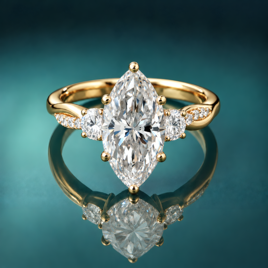 Gold three-stone engagement ring with marquise center diamond and round side diamonds. Twist shank with accent small diamonds.
