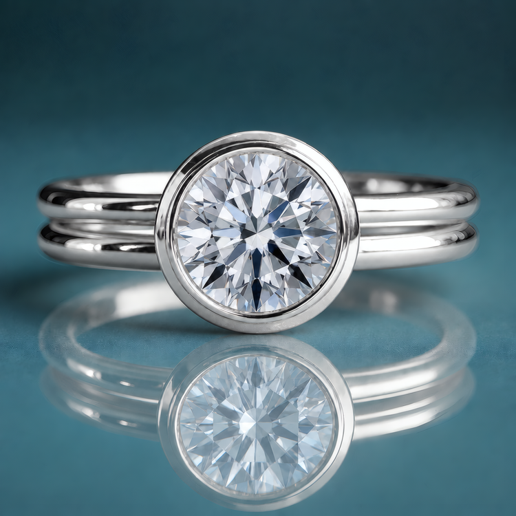 White gold bezel set round diamond solitaire engagement ring with a double round shank.