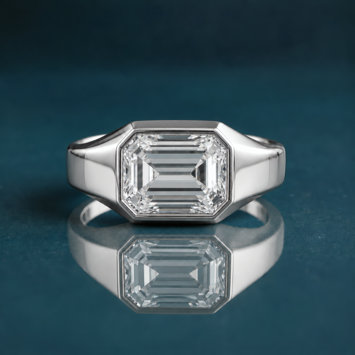 unique white gold solitaire engagement ring featuring a horizontal emerald-cut diamond and a thick band.