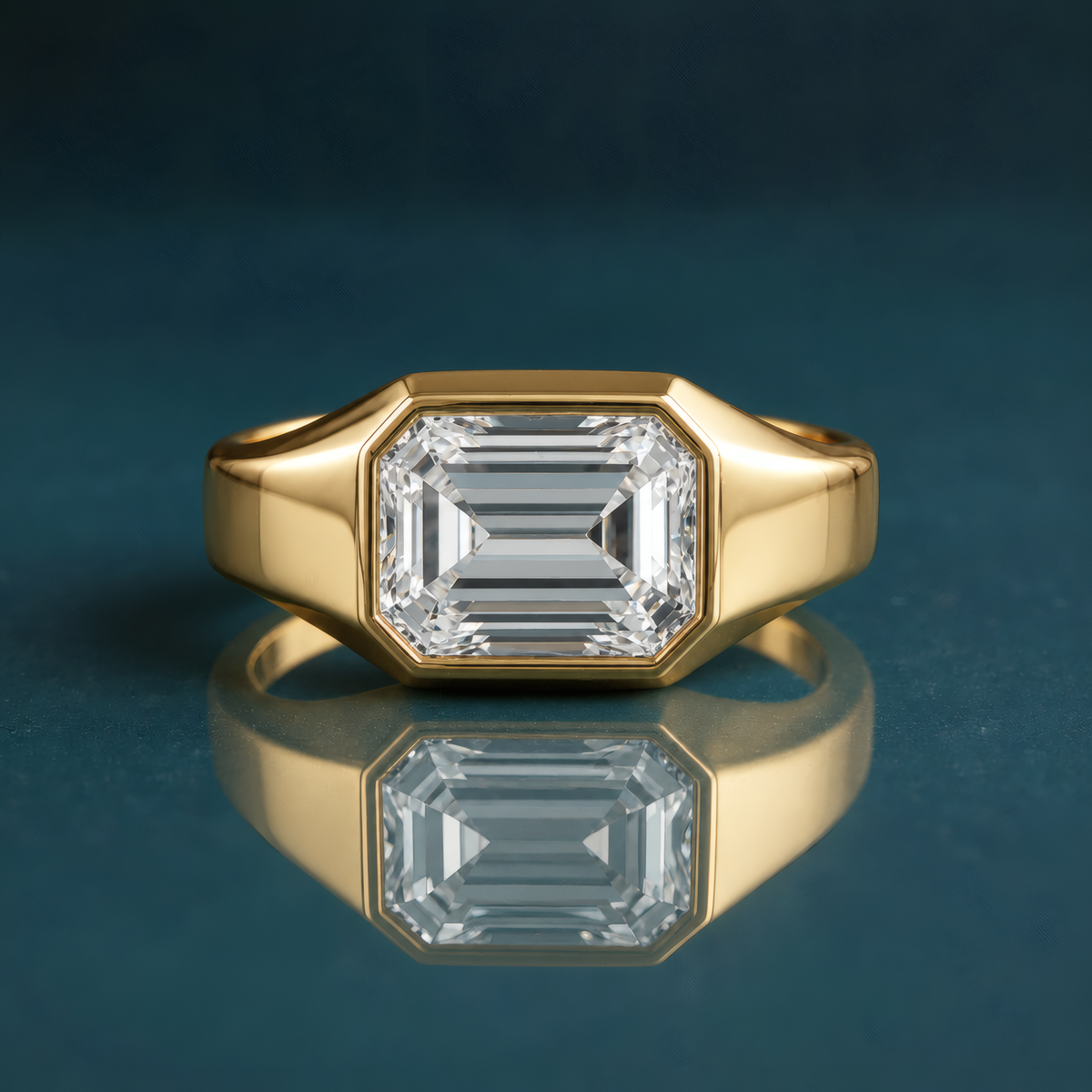 unique gold solitaire engagement ring featuring a horizontal emerald-cut diamond and a thick band.