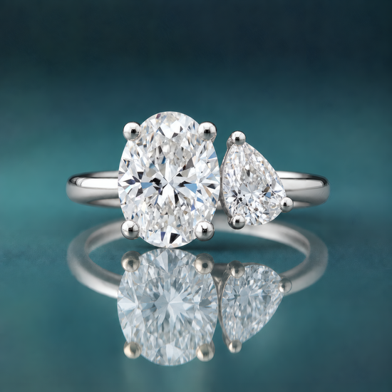 White gold two-stone engagement ring oval diamond pear diamond