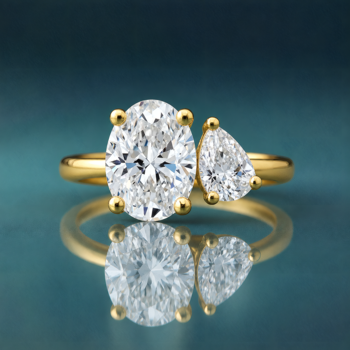 gold two-stone engagement ring oval diamond pear diamond