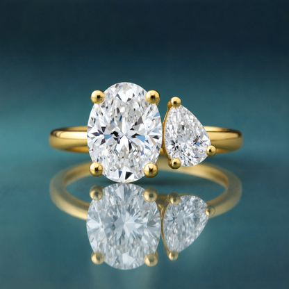 gold two-stone engagement ring oval diamond pear diamond