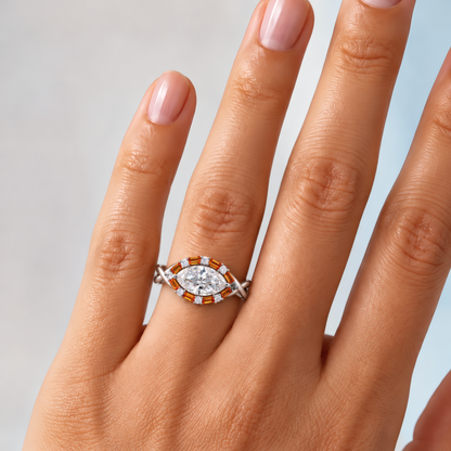 Vasa engagement ring in white gold worn on a woman's hand, showing the east-west marquise diamond in an amber baguette halo on a twisted band